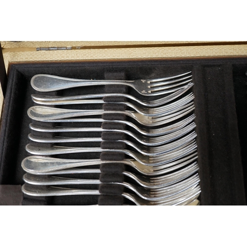 398 - A cased canteen of French Christofle silver plated beaded pattern cutlery, 49cm wide