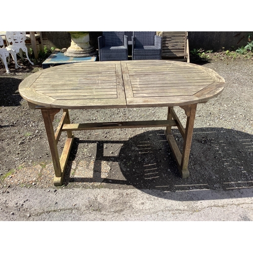 43 - A weathered teak extending garden table, width 150cm, depth 100cm, height 74cm, together with six te... 