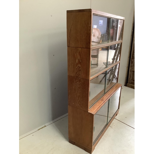 45 - A Minty four section oak glazed bookcase, width 89cm, depth 30cm, height 134cm