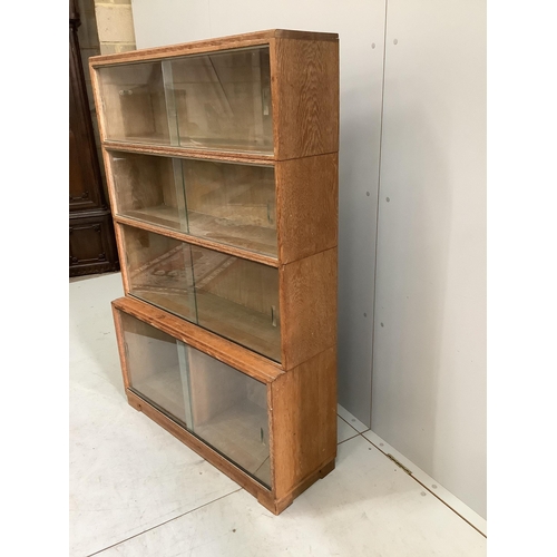 45 - A Minty four section oak glazed bookcase, width 89cm, depth 30cm, height 134cm