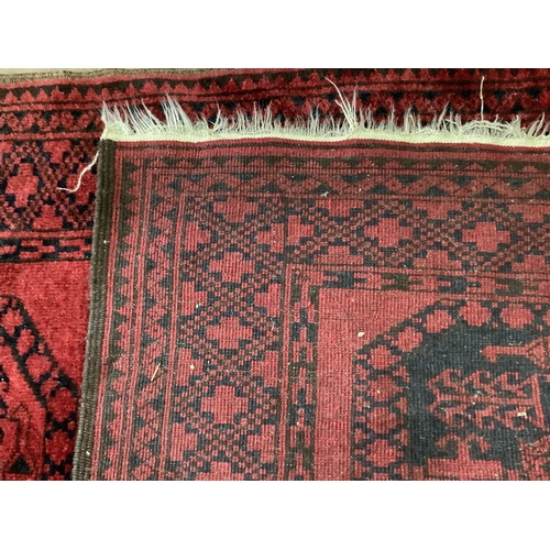 51 - Two Afghan red ground rugs, larger 170 x 120cm