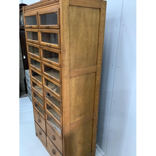 54 - A mid century oak twenty drawer haberdashery cabinet, width 92cm, depth 51cm, height 197cm