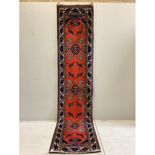 1062 - A Turkish red ground runner, 330 x 74cm