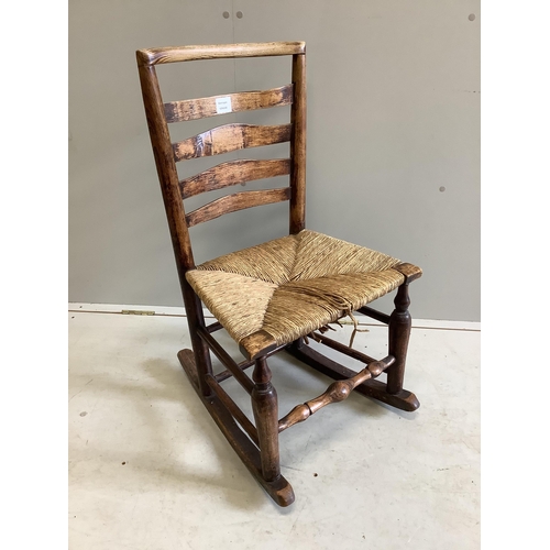 1089 - A 19th century ash rush seat ladderback rocking chair, width 48cm, depth 37cm, height 85cm