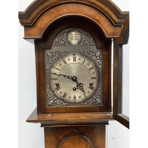 1100 - A reproduction 18th century style walnut grandmother clock with Whittington and Westminster chimes, ... 