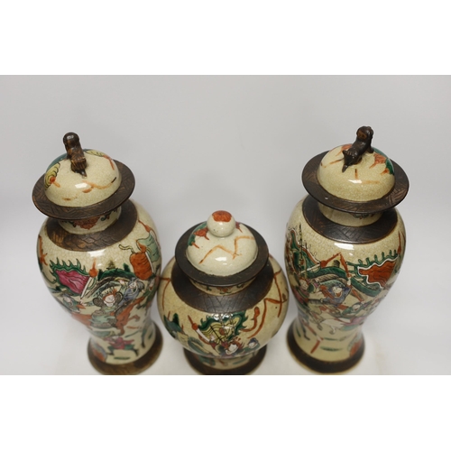 1382 - Three various Chinese crackleware famille rose jars and covers including a baluster example, largest... 