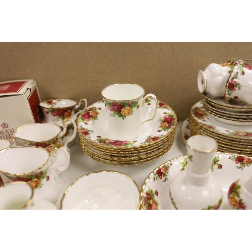 1398 - A Royal Albert Old Crown Roses dinner and tea service and a Doulton Lambeth vase