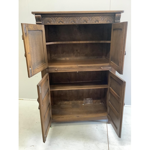 128 - A Jacobean Revival oak cocktail cabinet, width 94cm, depth 49cm, height 139cm