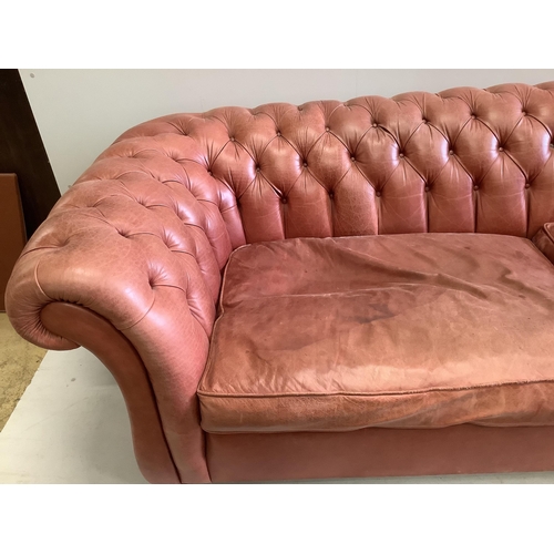 148 - A large Victorian style buttoned back pale red leather Chesterfield settee, width 270cm, depth 104cm... 