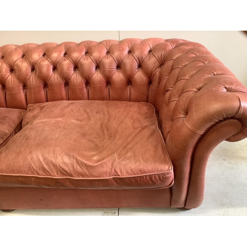 148 - A large Victorian style buttoned back pale red leather Chesterfield settee, width 270cm, depth 104cm... 