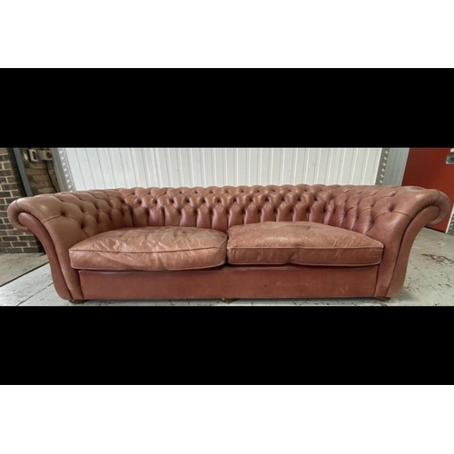 148 - A large Victorian style buttoned back pale red leather Chesterfield settee, width 270cm, depth 104cm... 