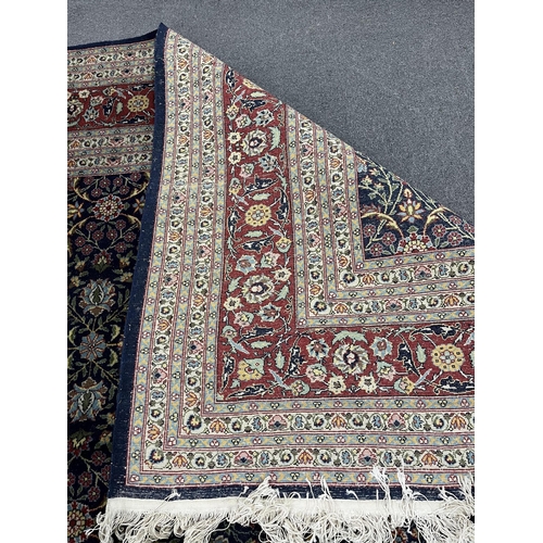 176 - A Turkish Hereke blue ground carpet, 425 x 294cm