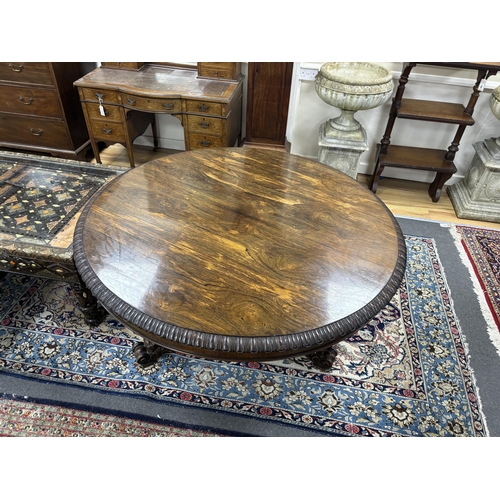 179 - A William IV circular rosewood centre table, the tilt top with lappet carved edge on single tapered ... 