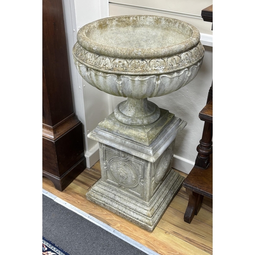 197 - A set of three circular reconstituted stone garden urns on square plinths, diameter 54cm, height 95c... 