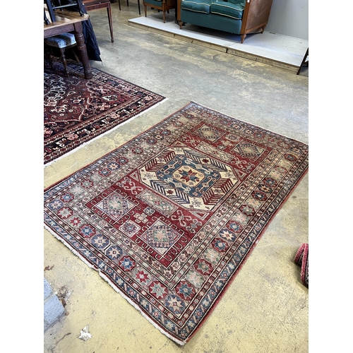 208 - A Caucasian style red ground rug, 207 x 150cm