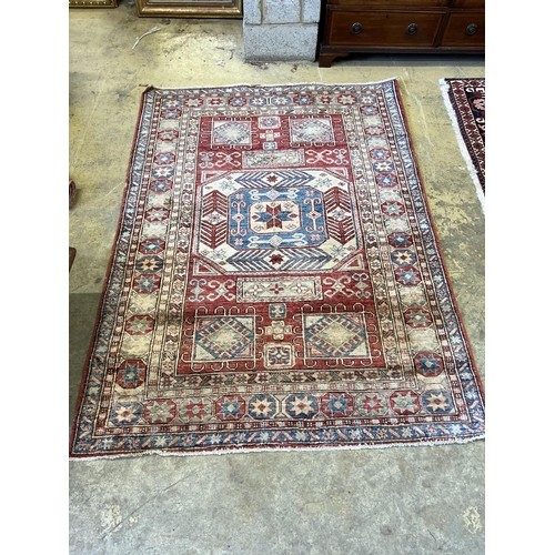 208 - A Caucasian style red ground rug, 207 x 150cm