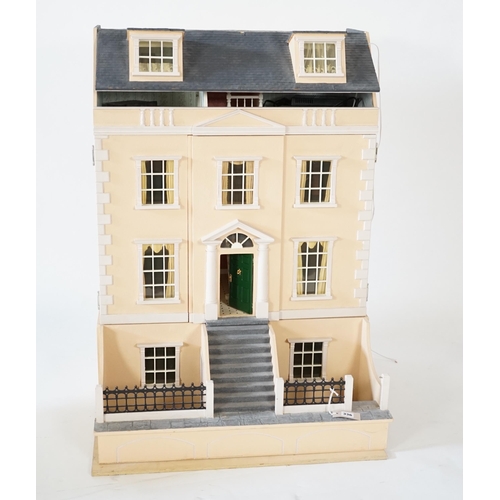 336 - A large modern Georgian style dolls house and extensive contents, with eight fully decorated rooms o... 