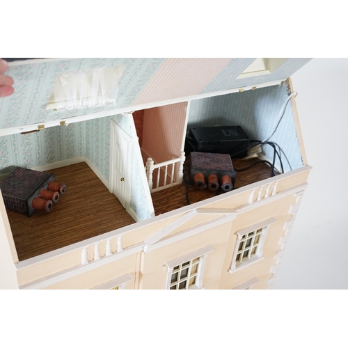 336 - A large modern Georgian style dolls house and extensive contents, with eight fully decorated rooms o... 