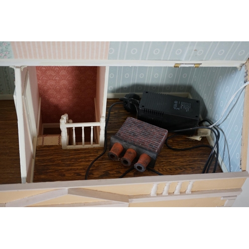 336 - A large modern Georgian style dolls house and extensive contents, with eight fully decorated rooms o... 