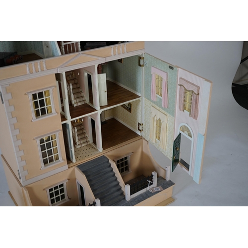 336 - A large modern Georgian style dolls house and extensive contents, with eight fully decorated rooms o... 