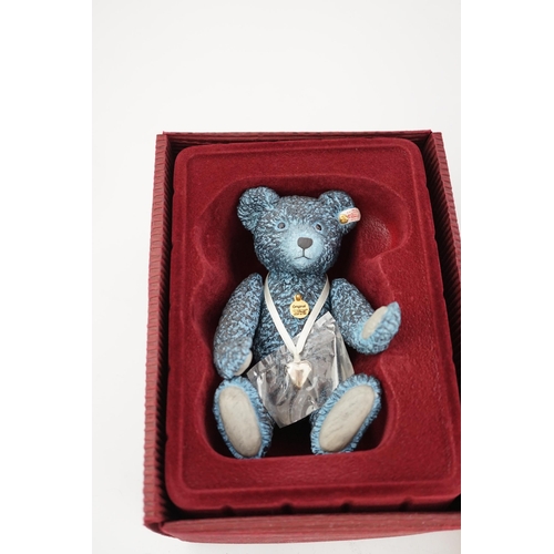 346 - An early Paddington bear, blue jacket, missing hat, a Steiff Ltd. edition lilac bear in box, and a p... 