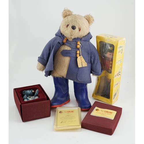 346 - An early Paddington bear, blue jacket, missing hat, a Steiff Ltd. edition lilac bear in box, and a p... 