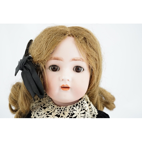 352 - A Kramer & Reinhard/S&H bisque head doll, pierced ears, original wig, clothes and shoes, 52cm