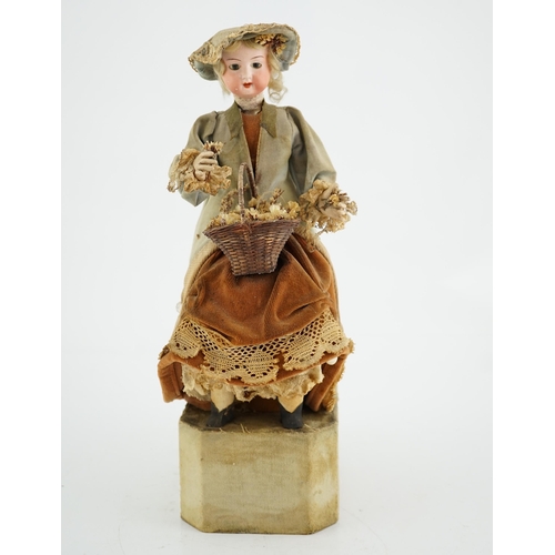 355 - A German automaton of a flower seller, 39cm high