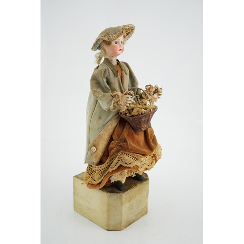 355 - A German automaton of a flower seller, 39cm high