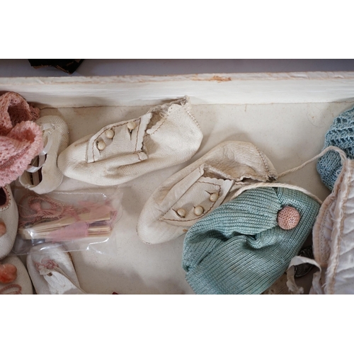 357 - A doll's trunk with assorted vintage clothes, shoes and doll's accessories