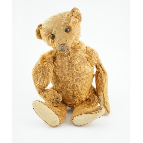 358 - A cinnamon Steiff bear  c.1908, with button paw pads, stuffing missing in arms, hair loss to head, m... 