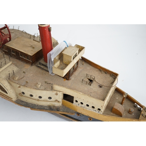 365 - A wooden model of a paddle steamer, with a well detailed deck and with some age to the model, howeve... 