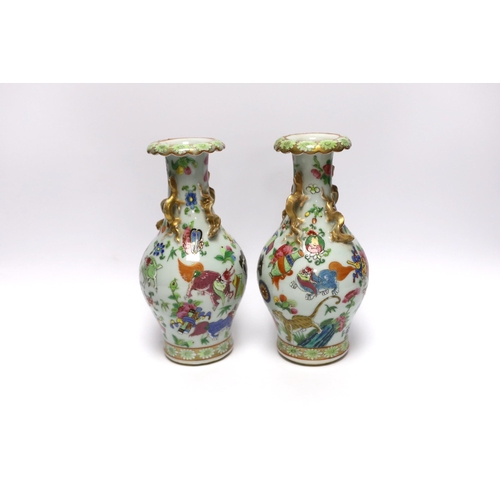 410 - A pair of 19th century Chinese famille rose mythical beasts vases, 24cm