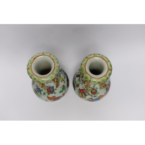 410 - A pair of 19th century Chinese famille rose mythical beasts vases, 24cm