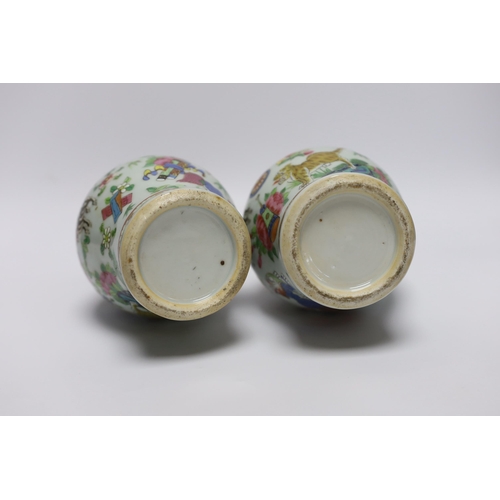 410 - A pair of 19th century Chinese famille rose mythical beasts vases, 24cm