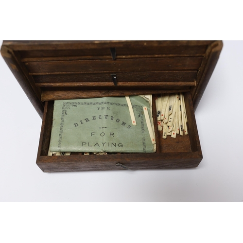 421 - A cased Chinese Mahjong set, bone pieces