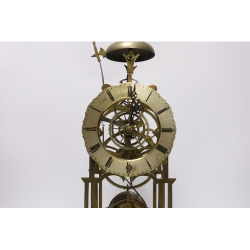 423 - A skeleton clock with Roman numeral dial, raised on white marble base, pendulum and key, 45cm