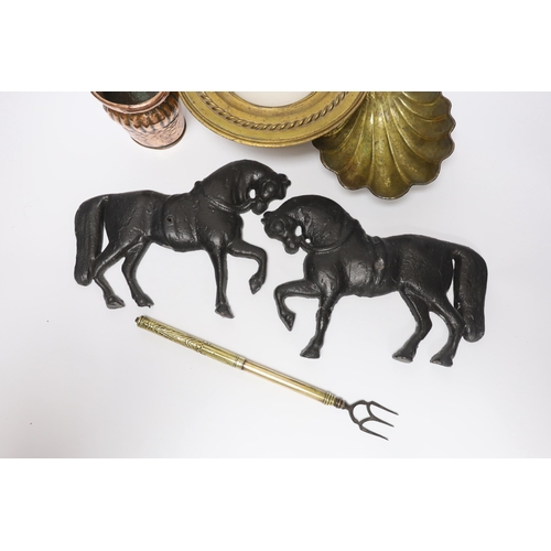 424 - A group of metalware to include a pair of lead horse wall mounts, a copper wall pocket, abrass sc... 