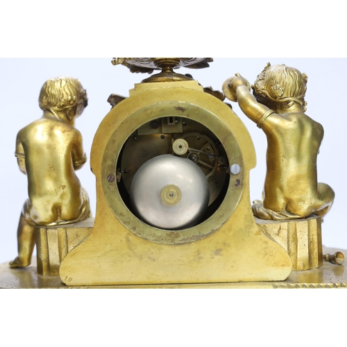 430 - A late 19th century French ormolu mantel clock surmounted with cherubs, 31cm