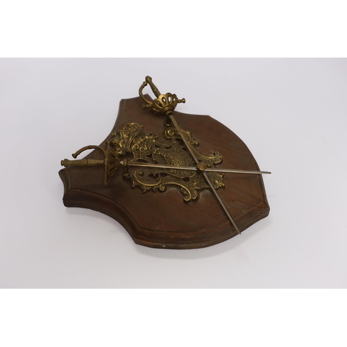 432 - A wall mounting pine shield with brass mounts and swords, 28cm