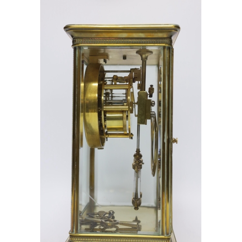 440 - A late 19th century four glass brass clock with key and pendulum, 27cm