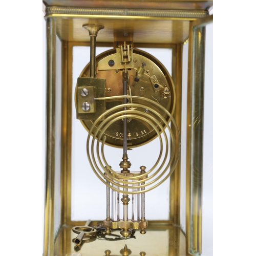 440 - A late 19th century four glass brass clock with key and pendulum, 27cm