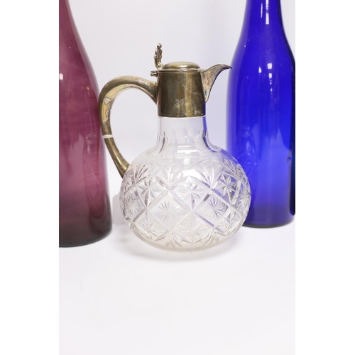 472 - A silver mounted glass claret jug and three coloured glass bottles, 37cm