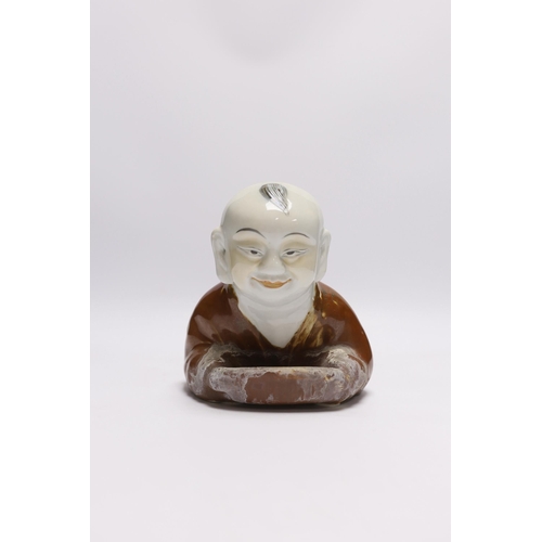 484 - A Chinese porcelain boy headrest, 29cm long