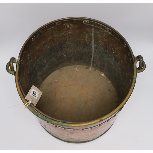 507 - A copper and brass cylindrical log bucket, with swing handle, 33cm high