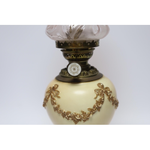 509 - A Royal Worcester blush ivory oil lamp with fluted glass shade, 46cm high