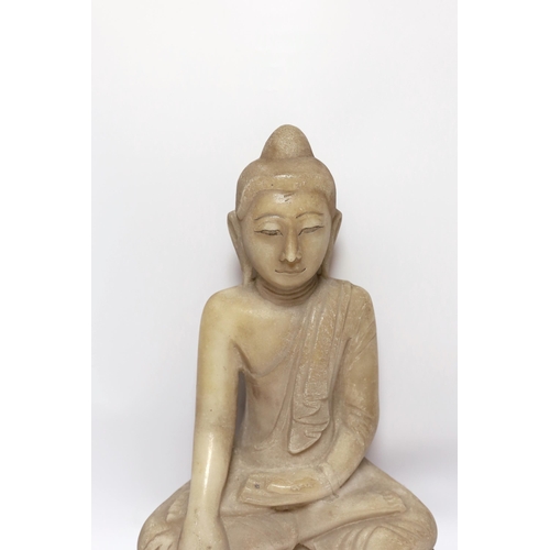 519 - A Burmese carved alabaster model of a seated buddha, 46cm