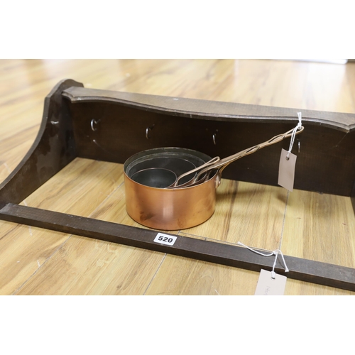 520 - A graduated set of four copper and brass handled saucepans with a beech hanging wall rack, rack appr... 