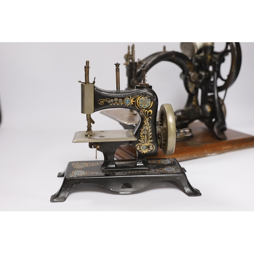 545 - A Victorian Wilcox and Gibbs sewing machine and a smaller sewing machine, 28cm high