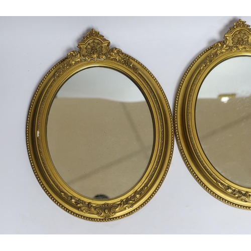 550 - A pair of small oval giltwood and composition wall mirrors, 35cm high